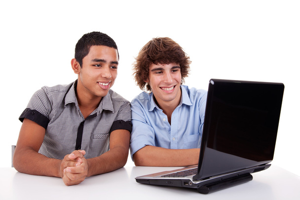 Two young man together on a laptop, isolated on white, studio shot - Photo, image