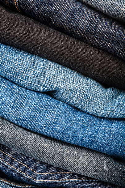Stack of blue jeans - 写真・画像