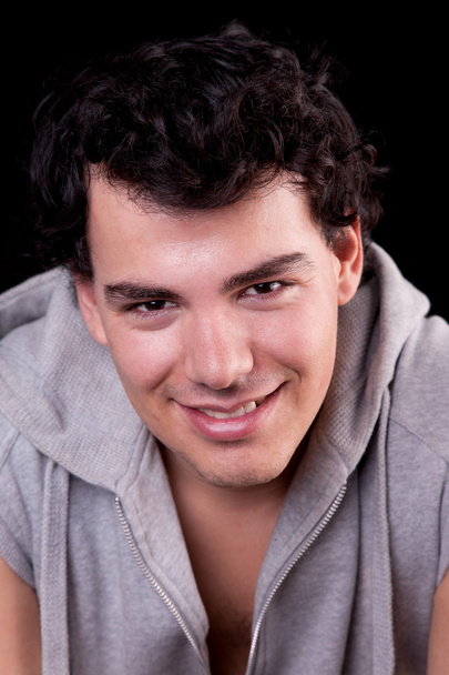 Handsome man, smiling, on black, studio shot - Foto, afbeelding