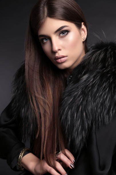 gorgeous sensual woman with dark straight hair wears elegant fur coat - Zdjęcie, obraz