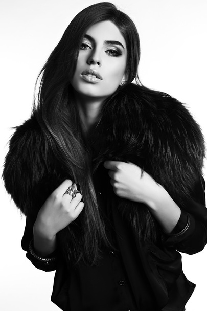 gorgeous sensual woman with dark straight hair wears elegant fur coat - Foto, afbeelding