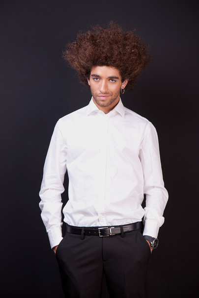 Portrait of a happy and young man isolated on black background. Studio shot. - 写真・画像