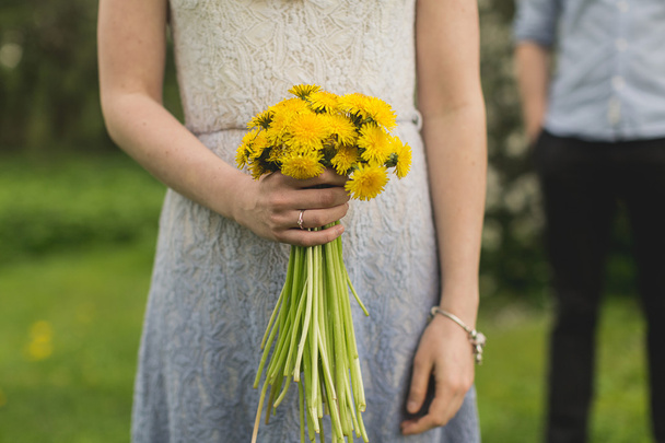 Girl with a bouquet of dandelions - Fotoğraf, Görsel