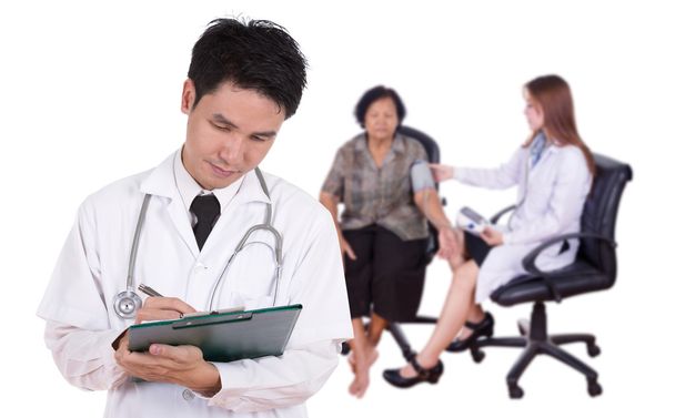 doctor writting medical report with female doctor measuring bloo - Photo, Image