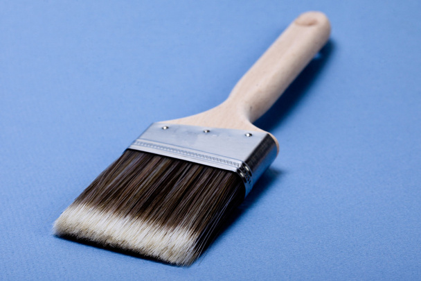Brush on blue background - Φωτογραφία, εικόνα