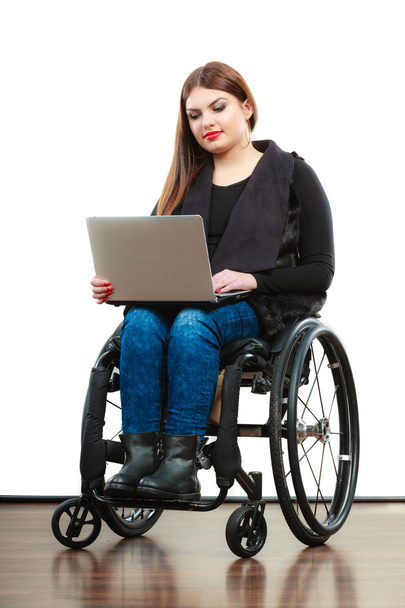 Woman invalid girl on wheelchair using computer - Фото, изображение