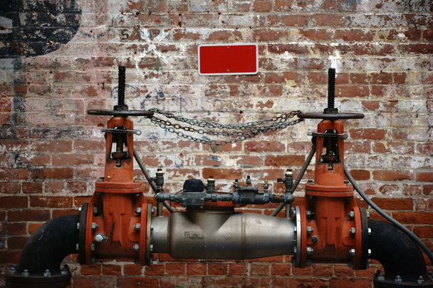 Pumping station in front of brick wall - Photo, Image