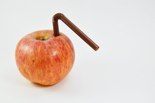 apple and plastic straw stab - Foto, afbeelding