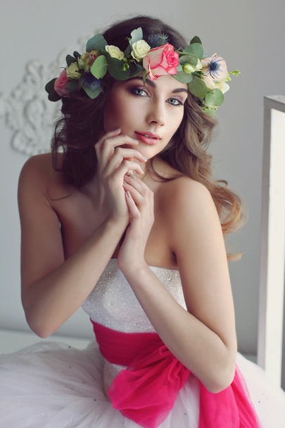 Modern and stylish bride in a floral wreath on her head and with - Φωτογραφία, εικόνα