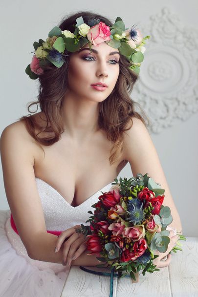 Modern and stylish bride in a floral wreath on her head and with - Fotoğraf, Görsel