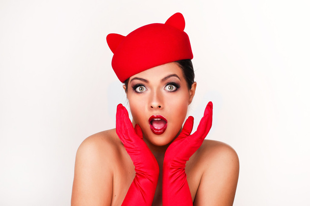 Charming and flirting girl in a funny red hat, the image of a pl - Photo, Image
