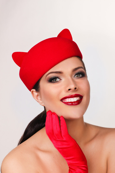 Charming and flirting girl in a funny red hat, the image of a pl - Fotografie, Obrázek