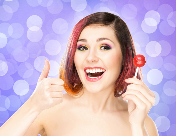 Beautiful smiling woman with a lollipop - Fotografie, Obrázek