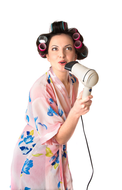Woman sings karaoke on hair dryer - Fotografie, Obrázek