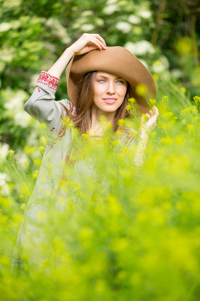 Spring woman in green garden enjoying the sunny day - Photo, Image