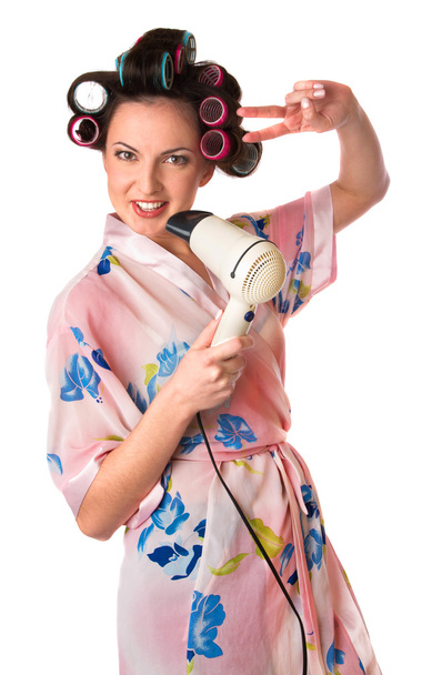 Woman sings karaoke on hair dryer - 写真・画像