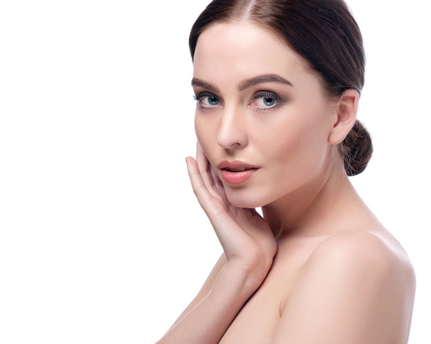 Beauty Woman Face closeup. Beautiful brunette young spa model girl with perfect skin. Skin care concept. Fresh Clean Skin. Portrait of female looking at camera and smiling. Beige background - Photo, Image