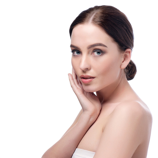 Beauty Woman Face closeup. Beautiful brunette young spa model girl with perfect skin. Skin care concept. Fresh Clean Skin. Portrait of female looking at camera and smiling. Beige background - Photo, Image