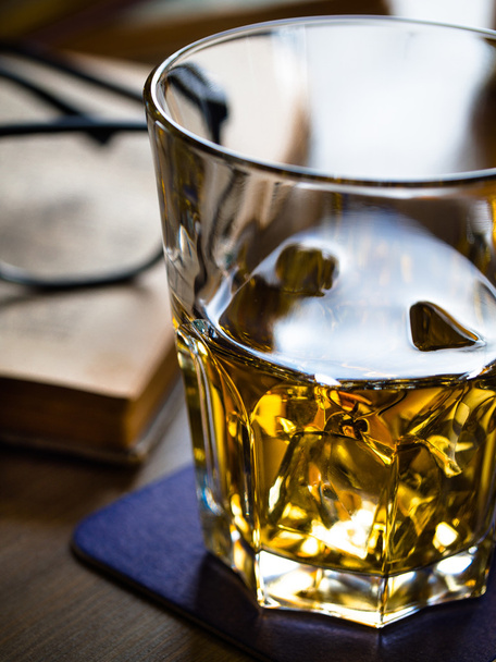 Whiskey on the rocks and scholar books - 写真・画像