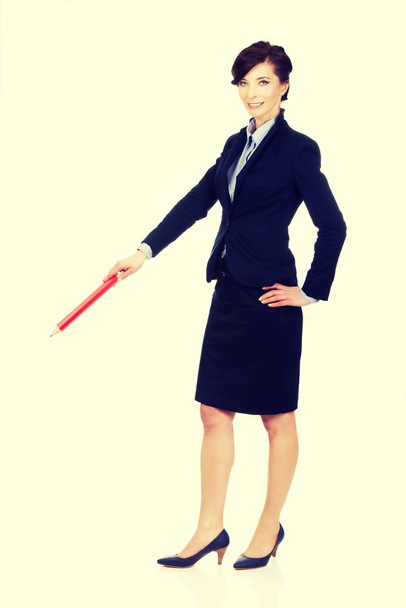 Businesswoman pointing down with pencil. - Foto, Imagen