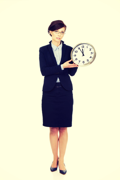 Business woman holding clock in hands. - Φωτογραφία, εικόνα