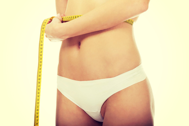 Slim woman measuring her waist. - Fotoğraf, Görsel