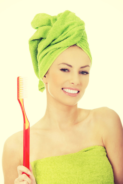 Beautiful woman with oversized toothbrush. - Fotó, kép