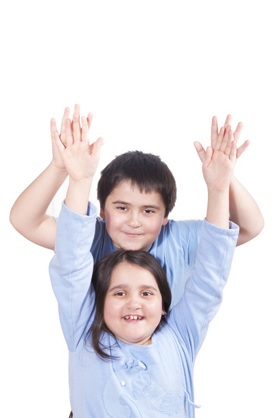 Joyful kids raised their hands up on a white background - Photo, image