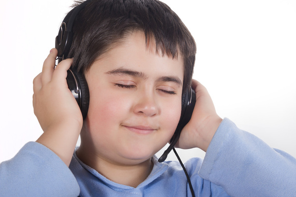 Boy holds two hands headphones and enjoying the music - Fotoğraf, Görsel