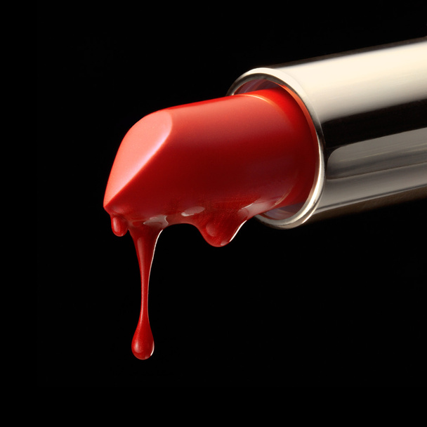 Red melting lipstick isolated on black background - Foto, Imagen