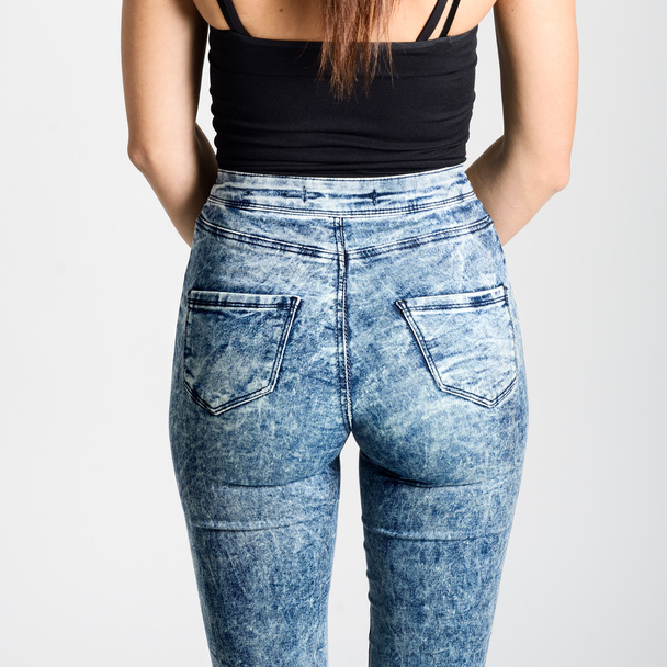 Back side of woman wearing high-waisted jeans - Foto, Imagem