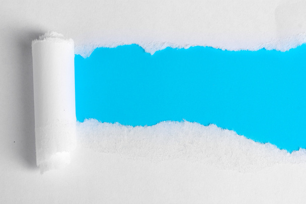 Torn paper with blue background - Foto, Imagem