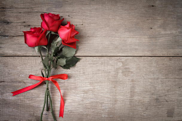 Valentines day background with red rose and ribbon on wooden.  Dual tone. - Zdjęcie, obraz