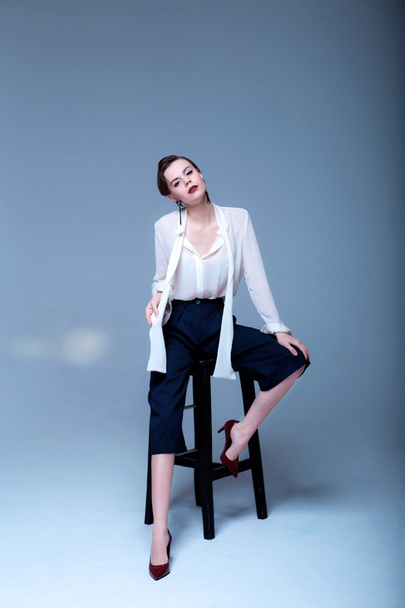 Fashion shooting of a young female model in a white shirt. - 写真・画像