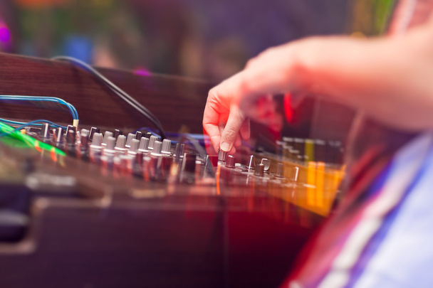 DJ Mixing music on console at the night club - Фото, изображение