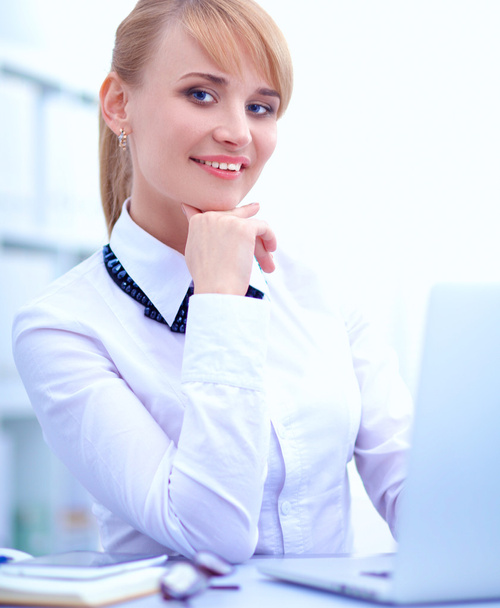 Portrait of  businesswoman sitting at  desk - Фото, изображение