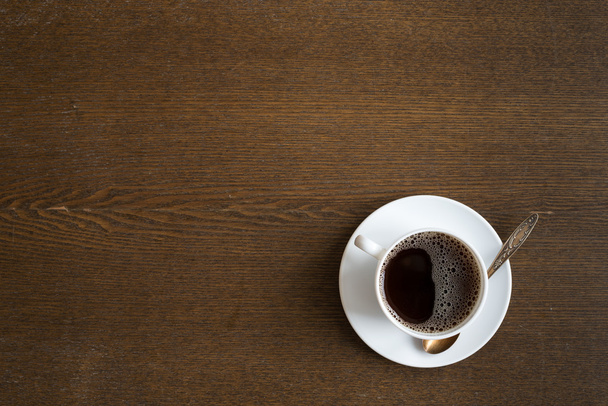 Cup of coffee on a grunge wooden table background - Photo, image