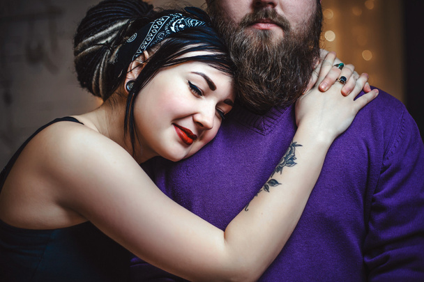 hugging young couple in love with tattoos - Fotografie, Obrázek