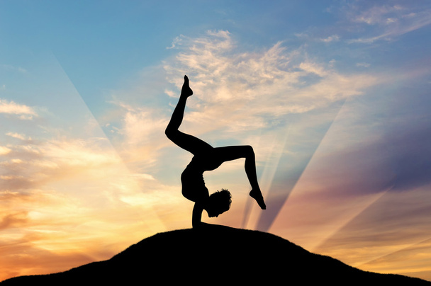 Silhouette of a girl practicing yoga - Zdjęcie, obraz