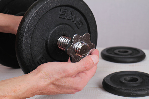 Bodybuilding concept. Man preparing barbell for working out close up. - Photo, image