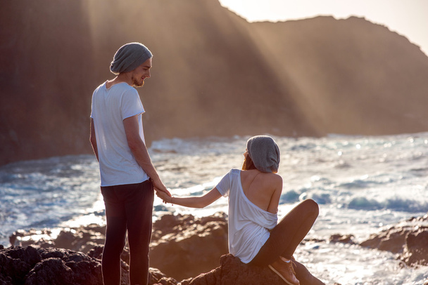 Couple together on the rocky coast - 写真・画像