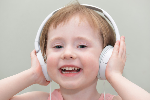 lustiges kleines Mädchen mit Kopfhörern - Foto, Bild