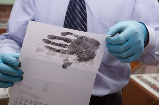 Deskundige neemt vingerafdrukken. onderzoek van de misdaad. - Foto, afbeelding
