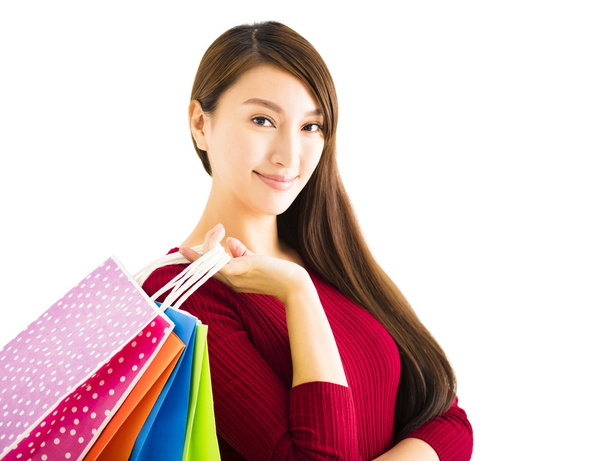 Lächelnde junge Frau mit Einkaufstüten - Foto, Bild