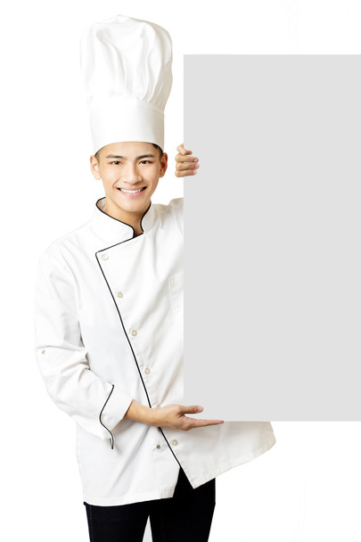 молодий азіатський шеф-кухар, що показує порожню дошку
   - Фото, зображення