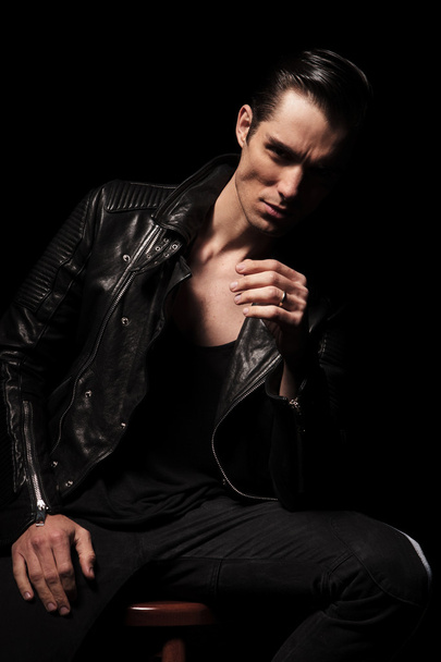 man in leather jacket posing seated while resting - Photo, Image