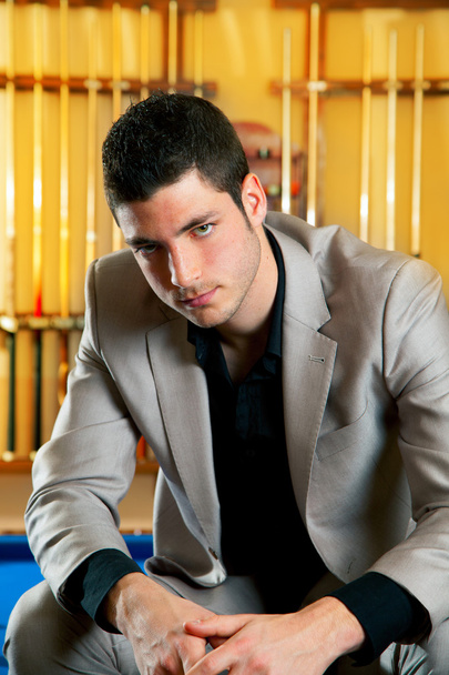 Handsome man with suit sitting in billiard pool - Фото, изображение