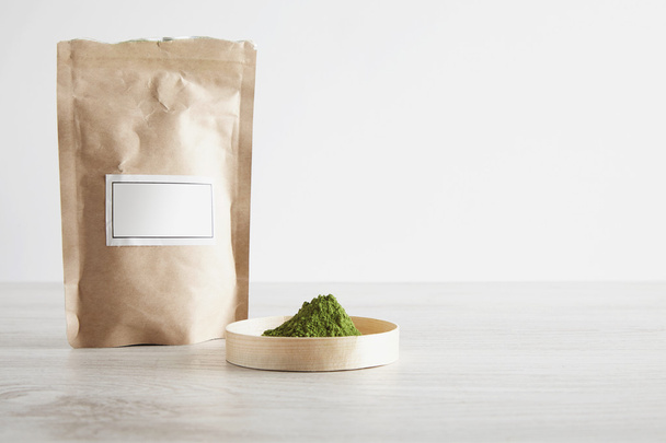 Paper bag and matcha tea on white table - Foto, imagen