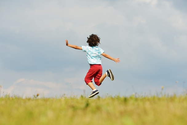 Happy kid on summer meadow - Photo, image