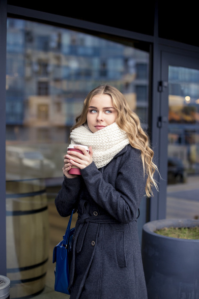 businesswoman in a hurry to work with a cup of coffee. outdoor shot - Zdjęcie, obraz